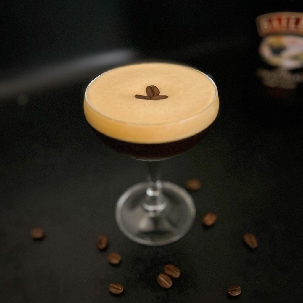 A cup of coffee with a single coffee bean resting on the foam, ready to be enjoyed - Resturent 1903 Melbourne